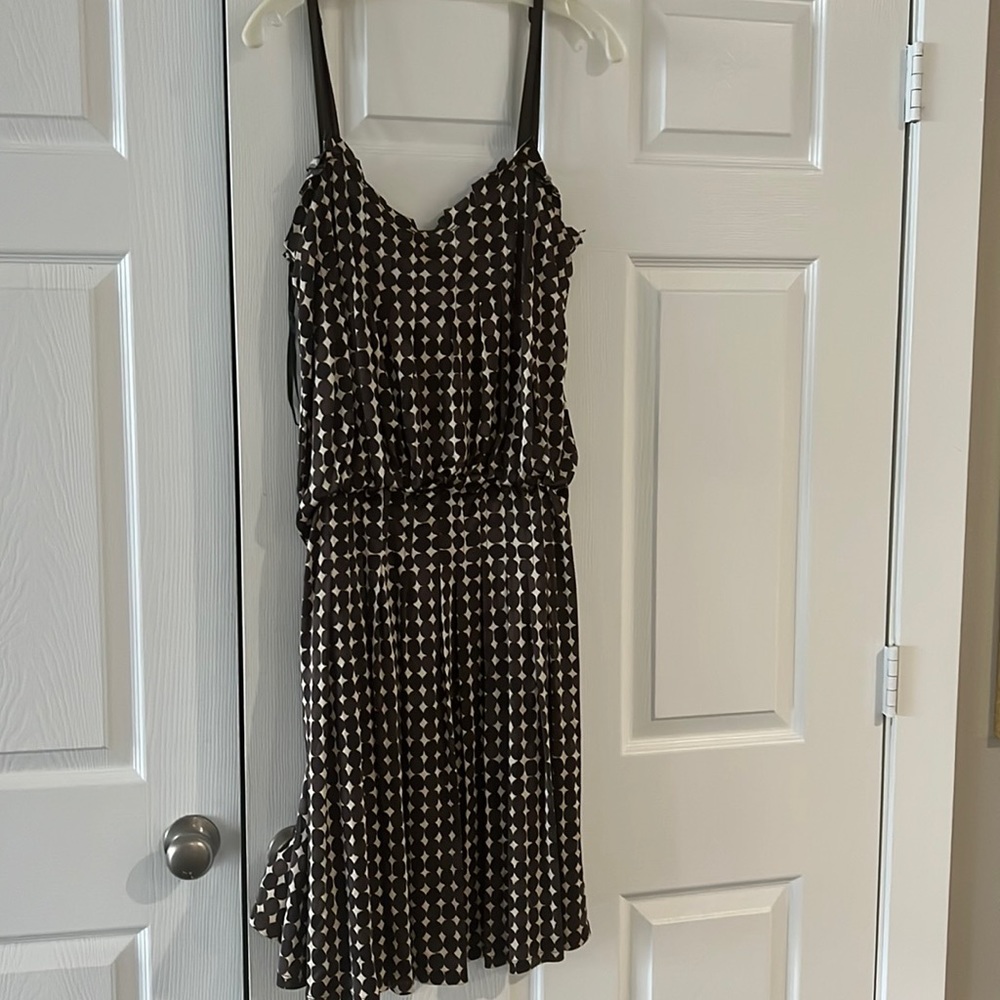 Brown strapped dress with brown and off white print. Elasticized at waist.